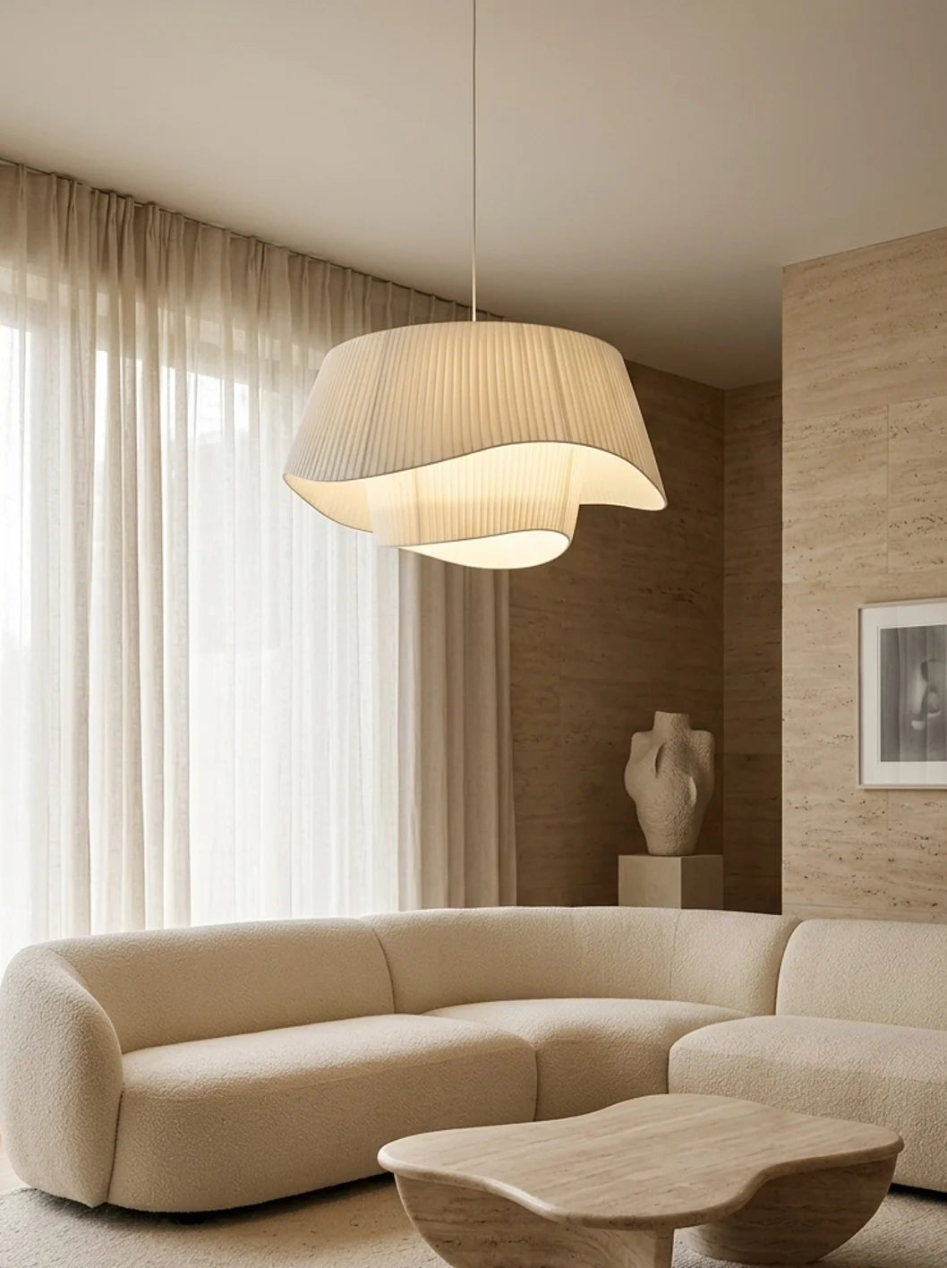 Modern living room with a beige sectional sofa, wooden coffee table, and pendant light.