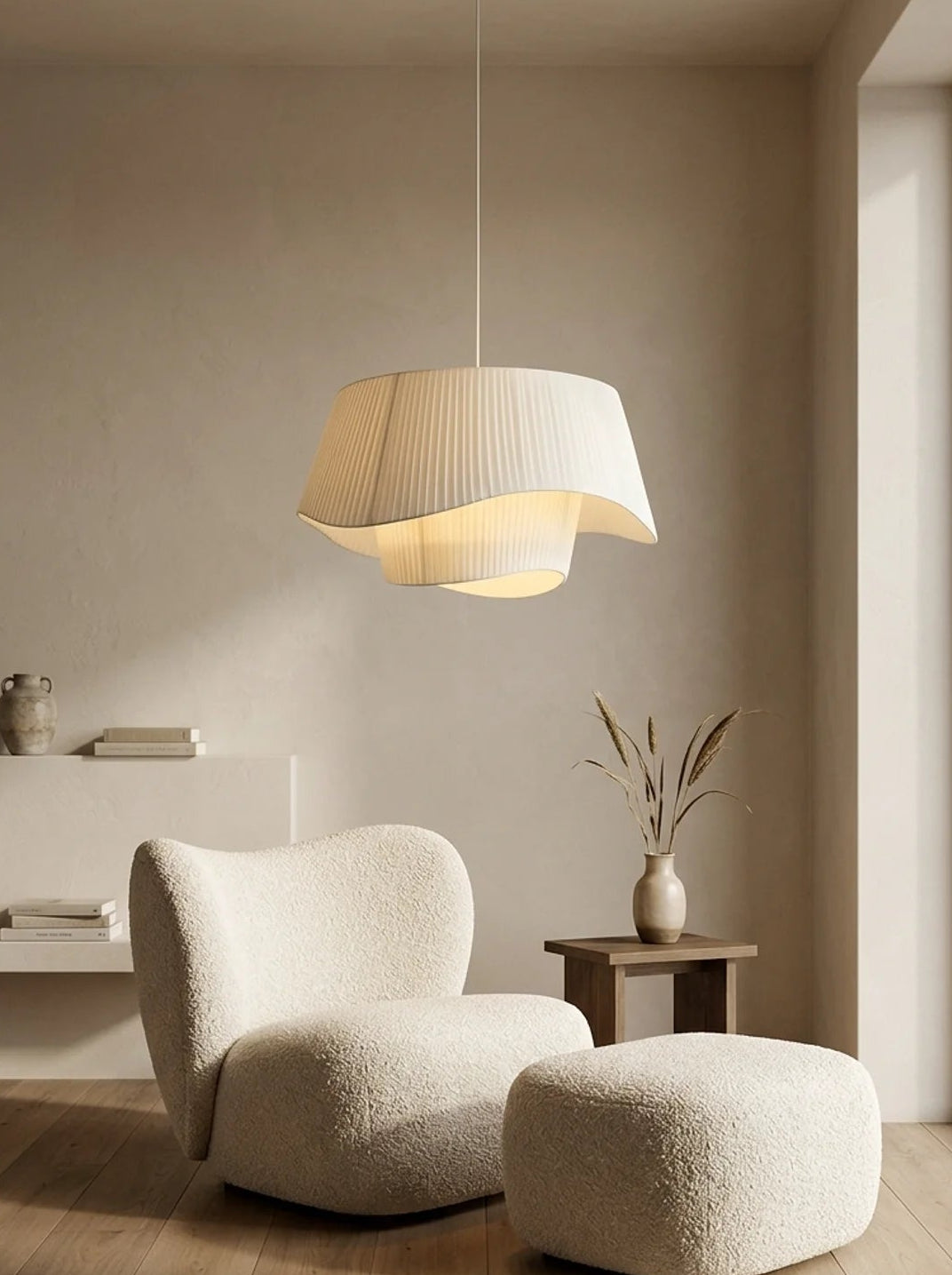 Modern interior with a white armchair and ottoman under a pendant light.