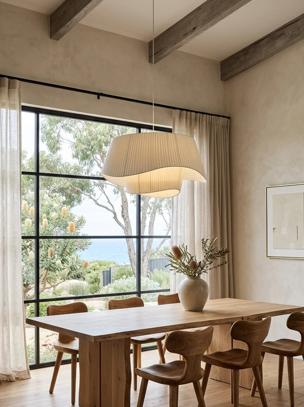 Dining room with wooden table and chairs, large window, and pendant light.